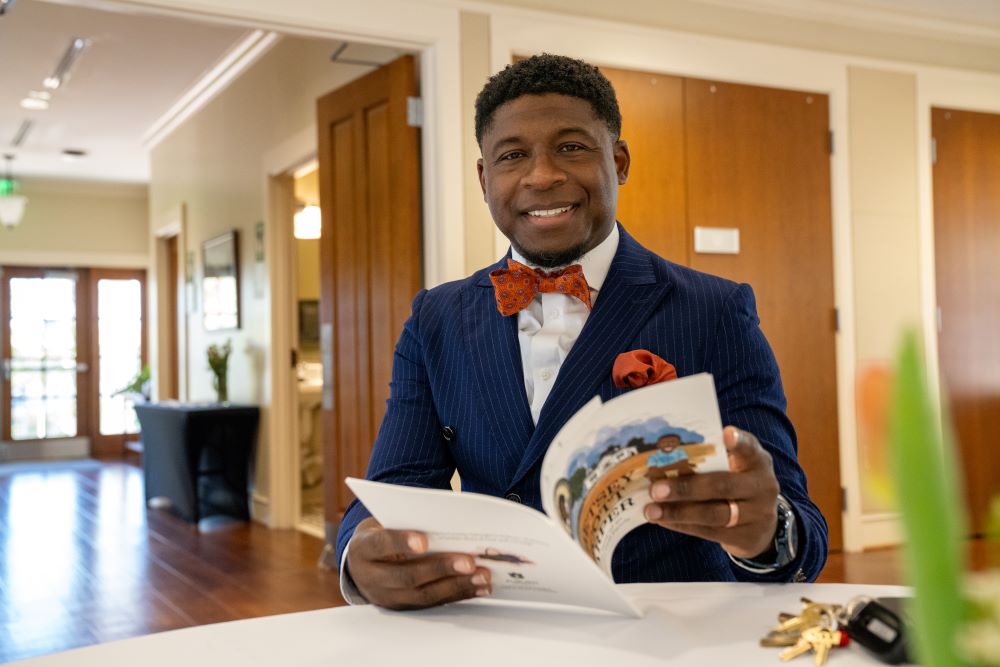 Terrance Vickerstaff holding Betsey Scott Harper book