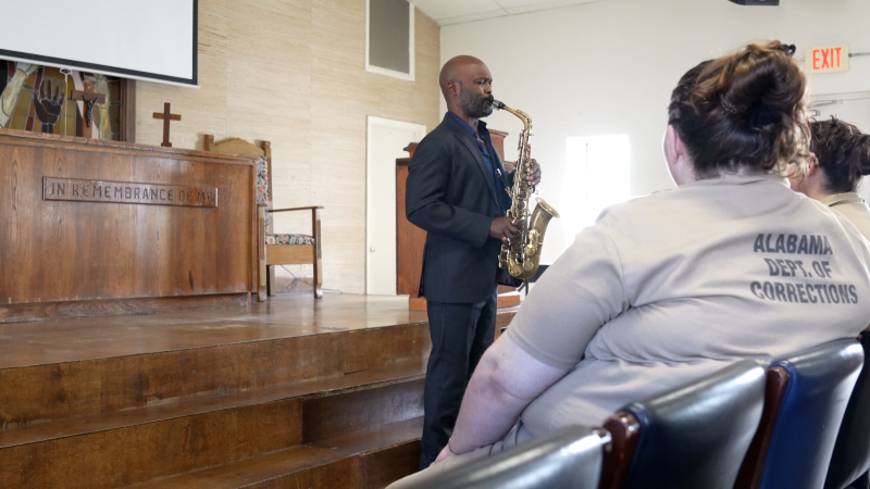 Khari Allen Lee plays the saxophone in the Tutwiler Prison chapel