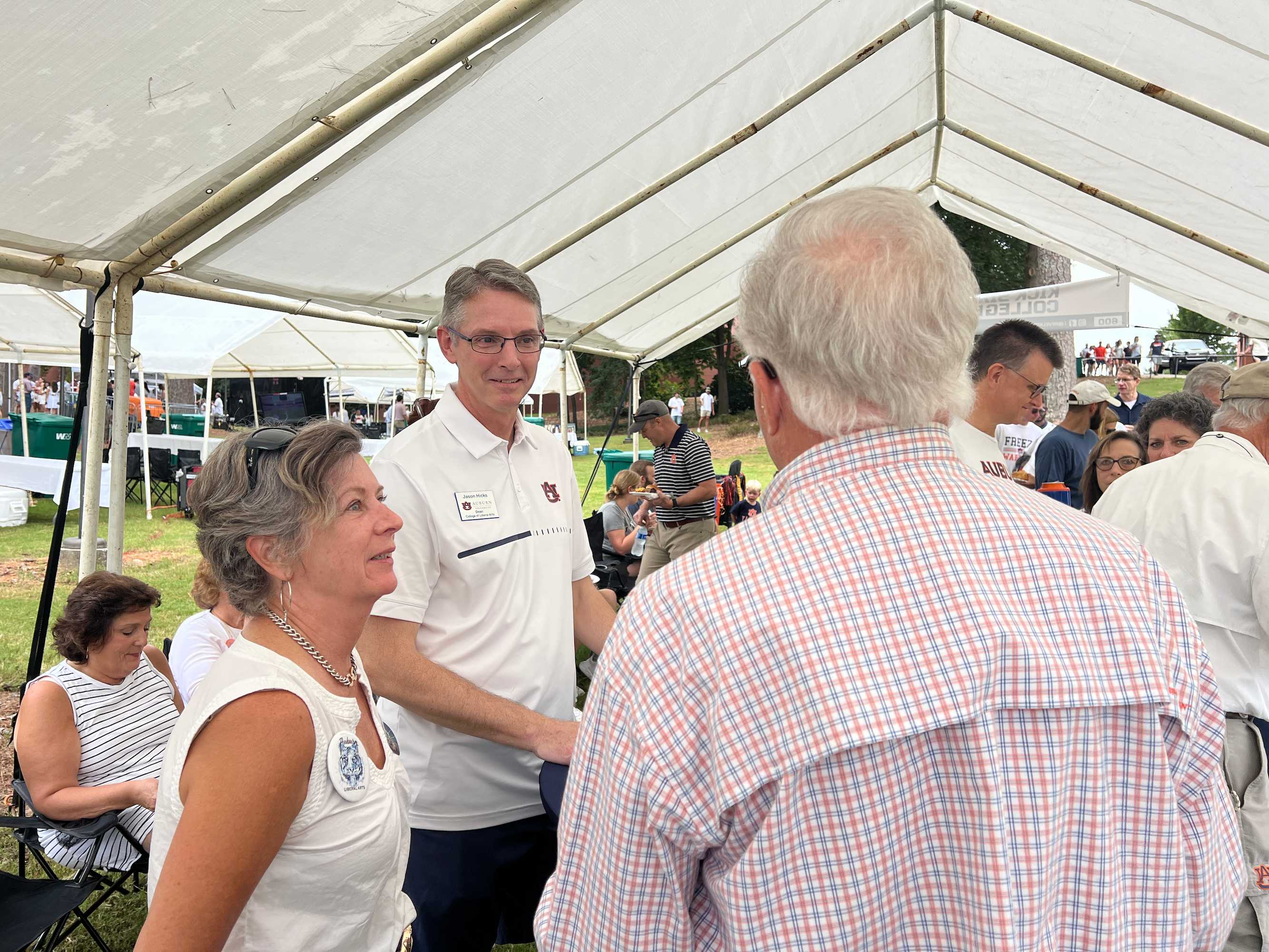 Dean Hicks with faculty and alumni at tailgate