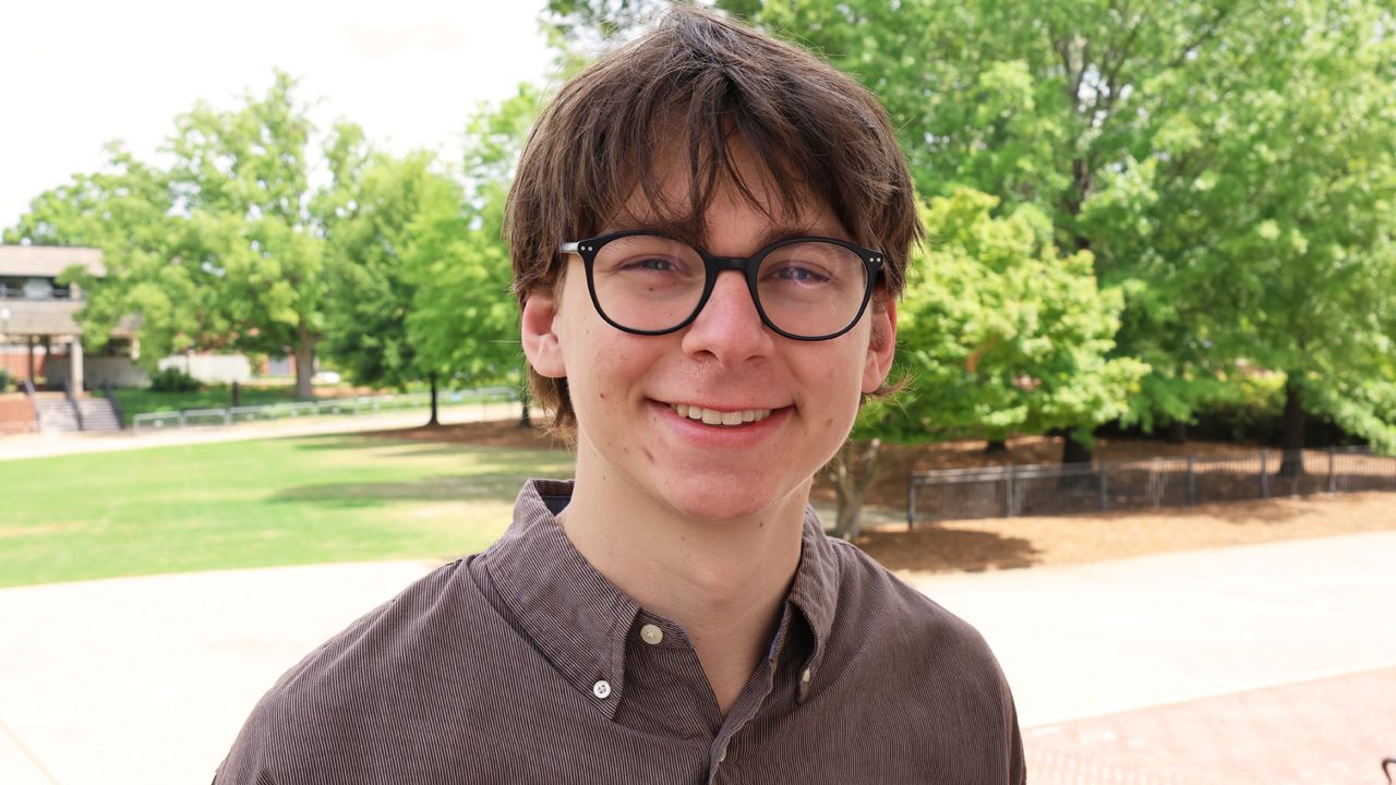 Will Lewis smiling for a photo on campus