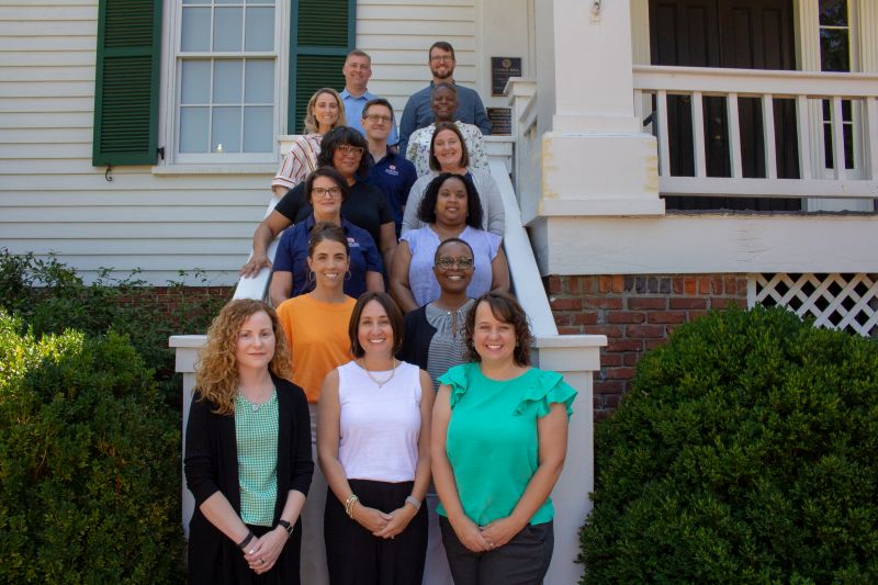 social work faculty standing in a group on stairs