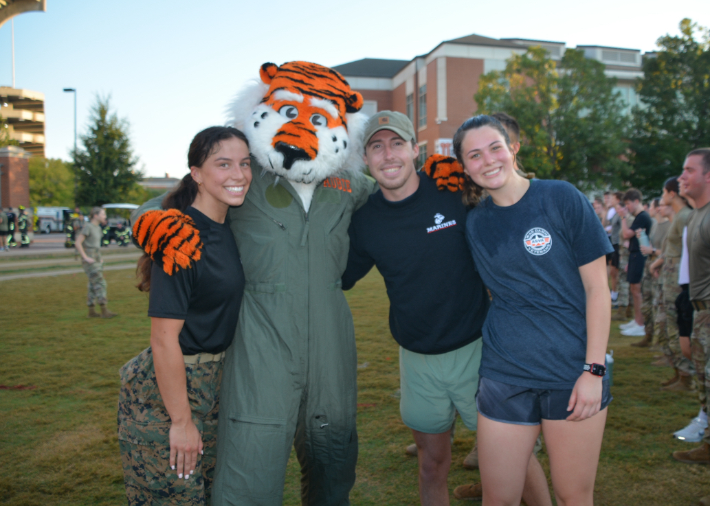 Aubie posing for a photo with student veterans