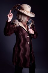 photo of woman in purple jacket and cowboy hat