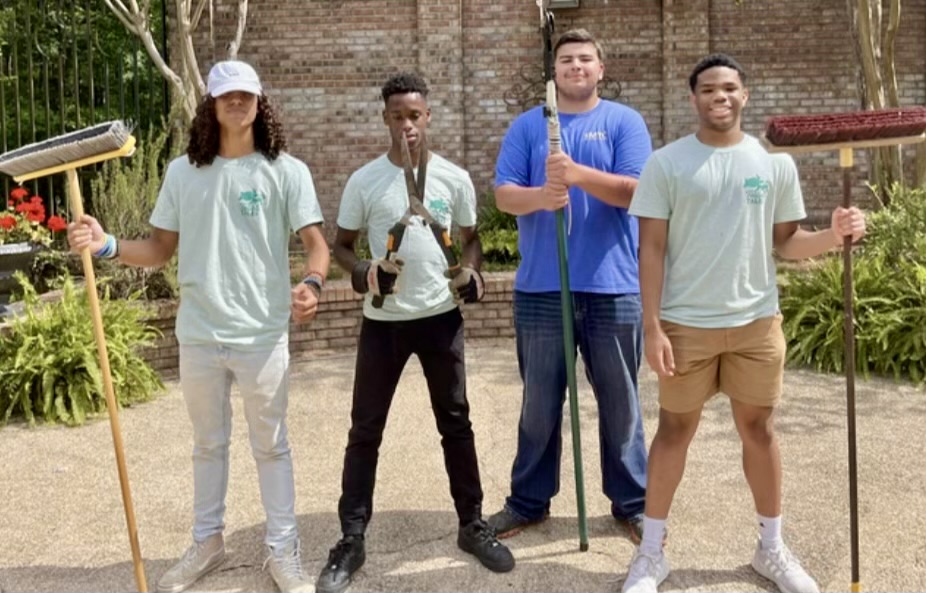 Student workers, left to right, Braedon Williams, Jarret Holcombe, Braxton McNeil, and Jordan Stewart, keep the grounds of Washington County Public Library tidy.