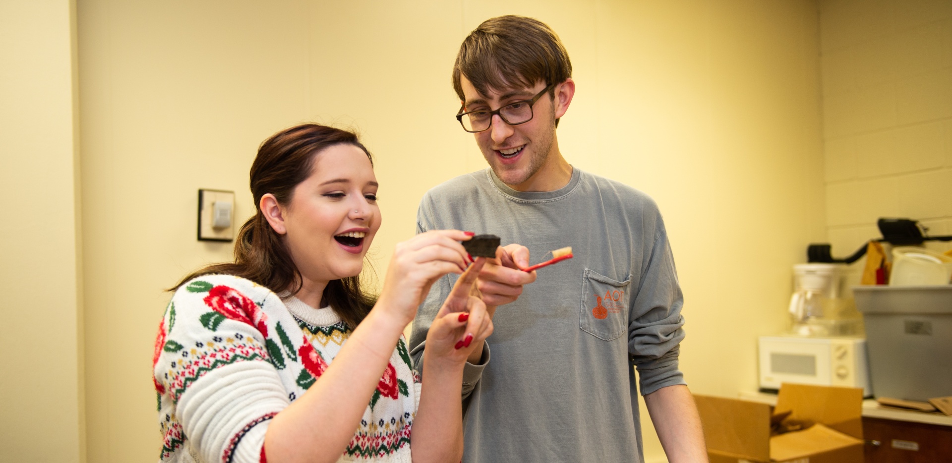Two students looking at a fossil