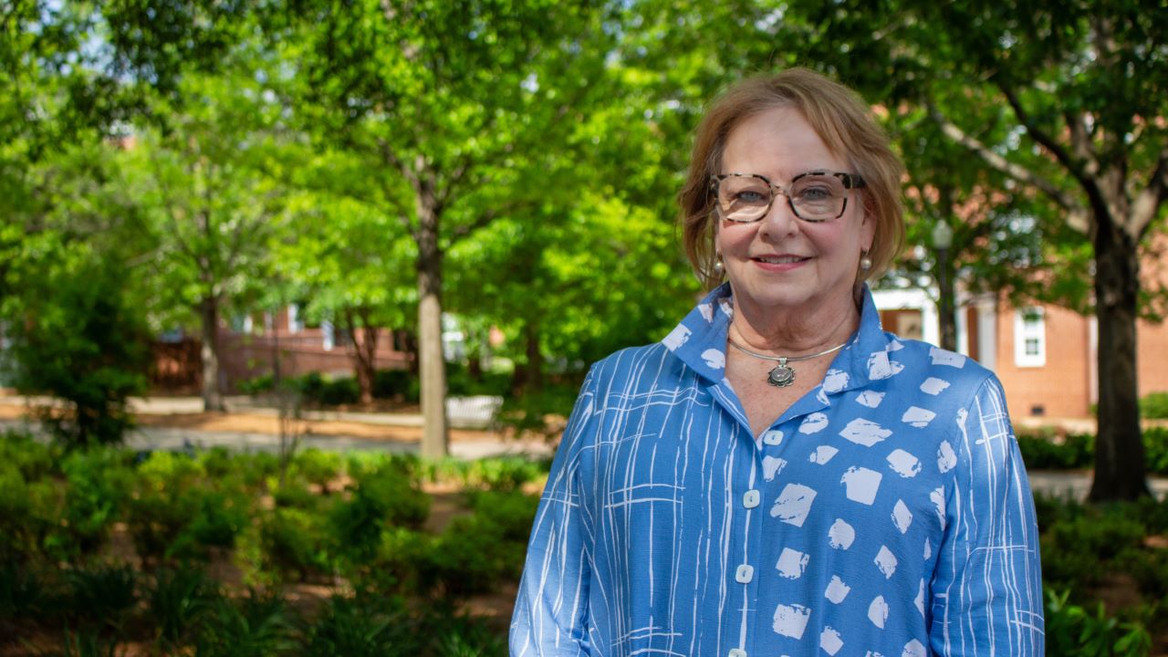 Susan Melton smiling for a photo on Auburn's campus