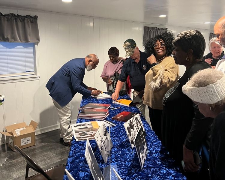 Chester Higgins signing books