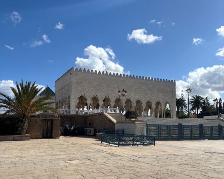A historic, intricately designed building in Morocco under a clear blue sky