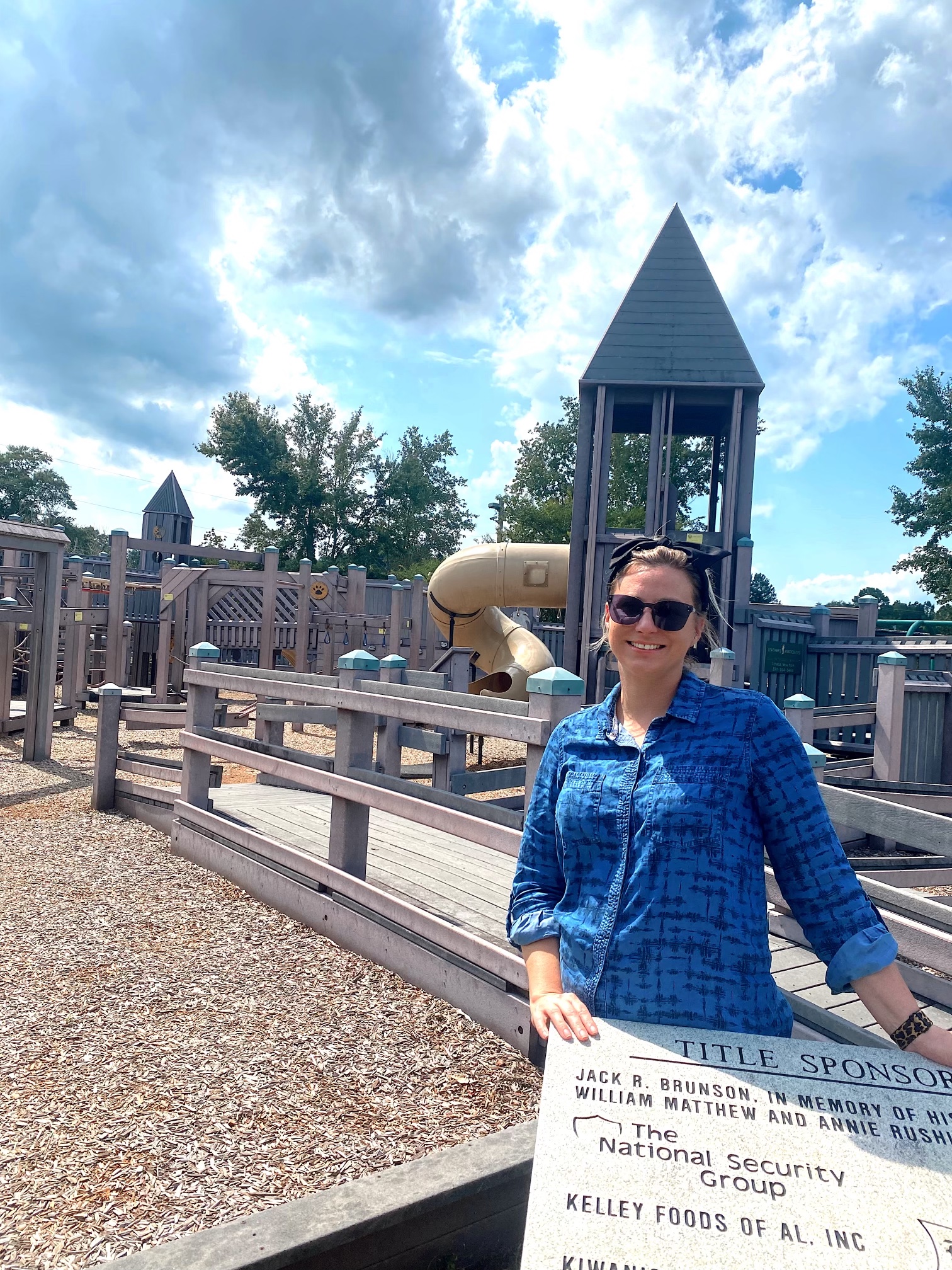 Courtney Pelham stands in front of a playground