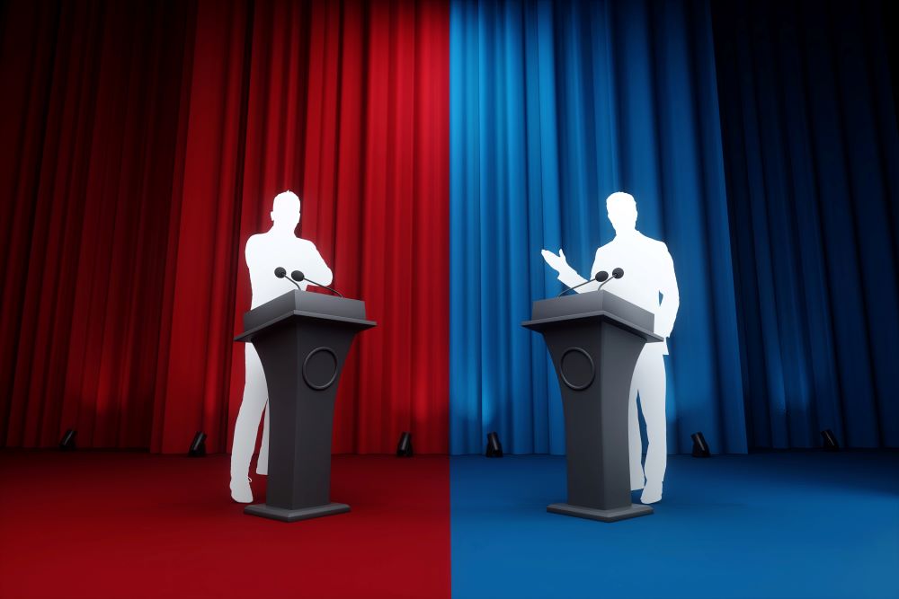 Silhouettes of two men behind podiums, one standing in front of a red curtain and one standing in front of a blue curtain