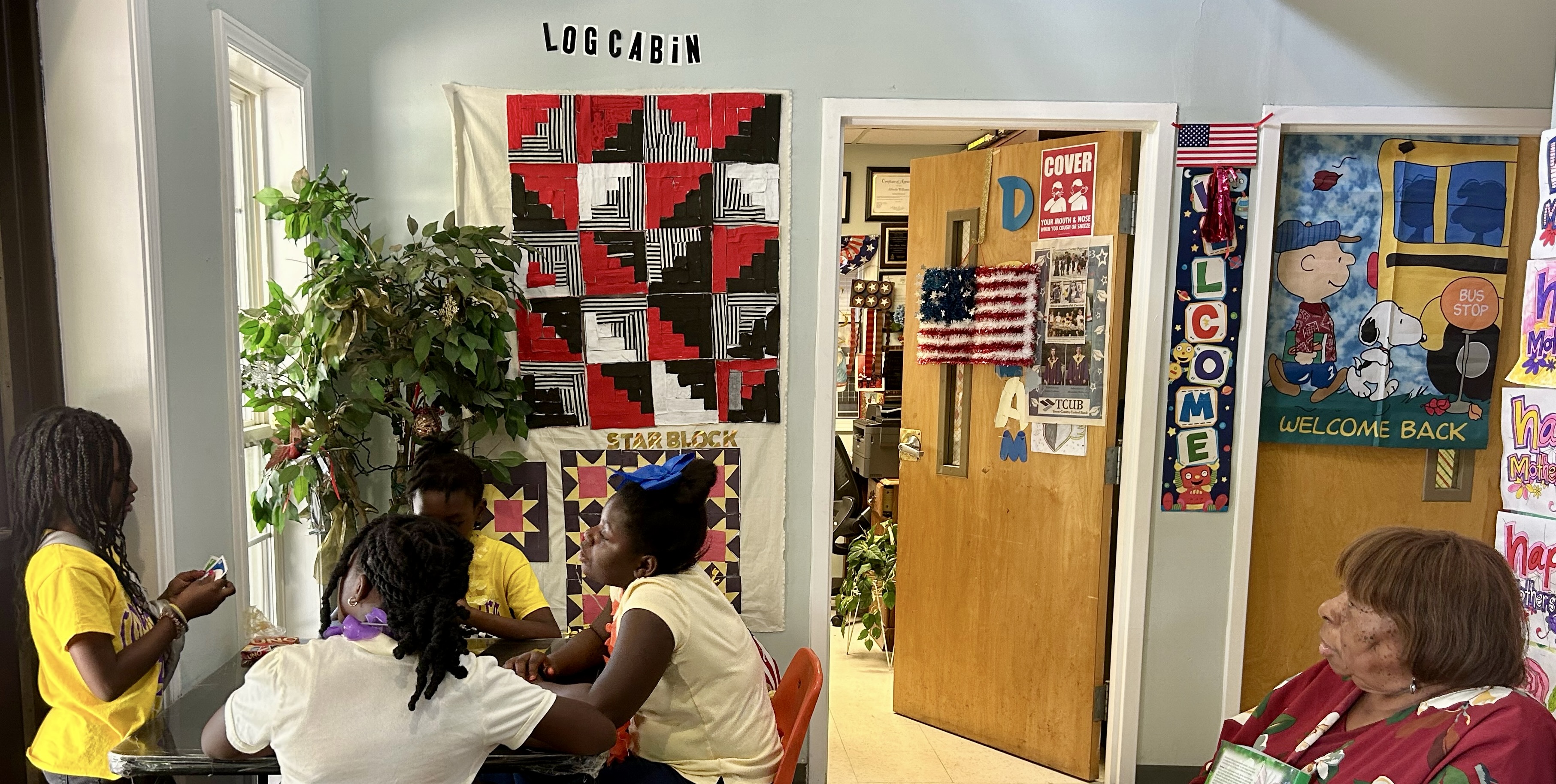 Williams supervises girls playing card games during summer program.