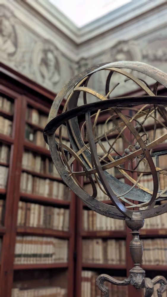 Globe on a desk in front of bookshelves in Rome's national library