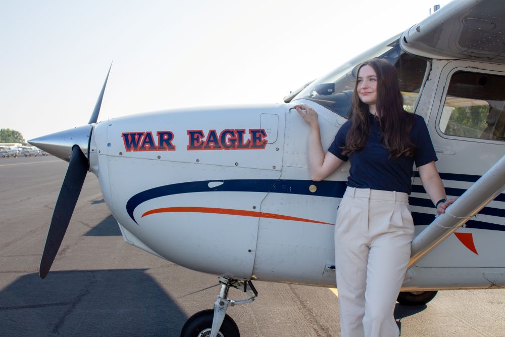 Jessica McGrath standing beside an Auburn airplane