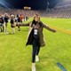 Mattie Whitney poses on the field at Jordan Hare Stadium