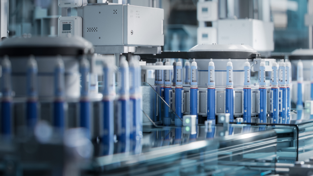 Insulin injection pens on conveyor line during production process at modern pharmaceutical factory