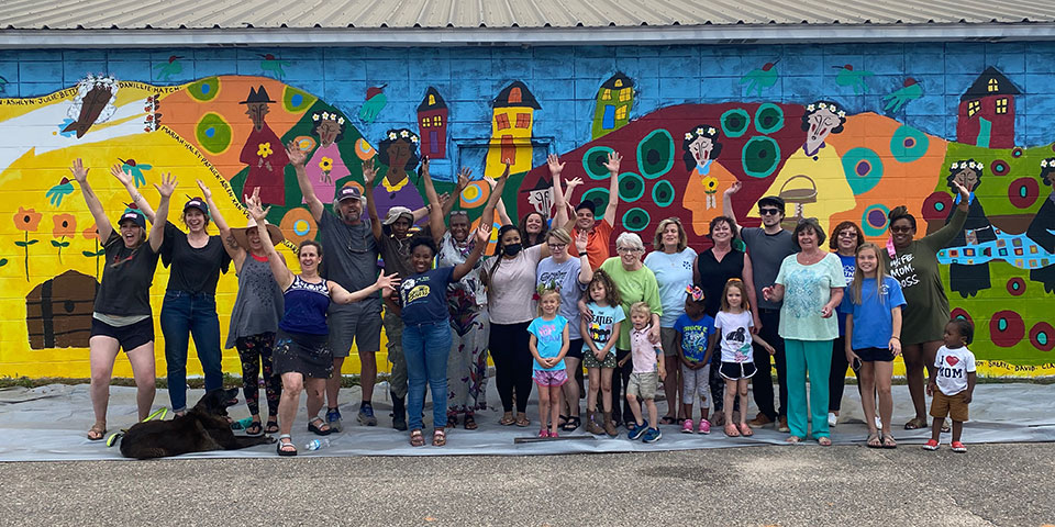 Living Democracy participants pose in front of mural