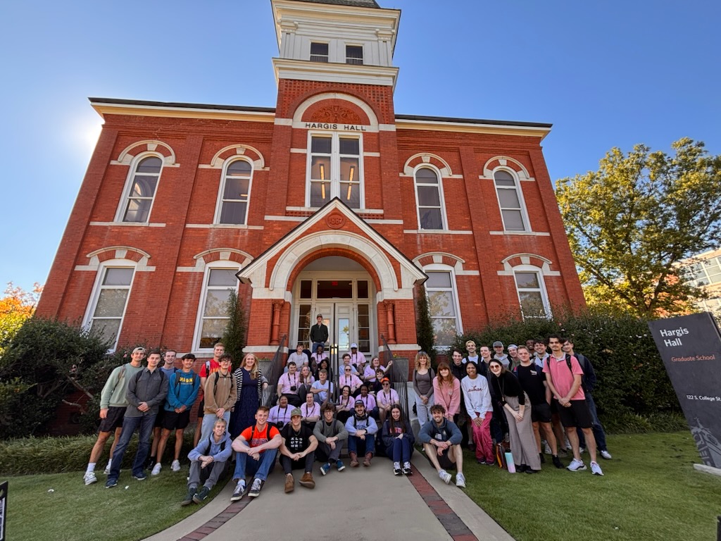Aviation Leadership students and BraveHeart artists pose for a group photo outside Hargis Hall