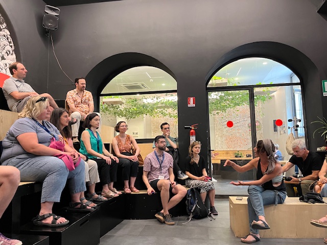 People sitting and listening to a speaker 