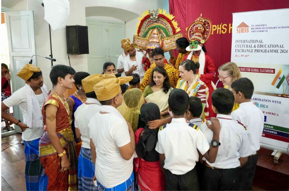 Laura West Ramkorun and a St. Joseph's teacher with students