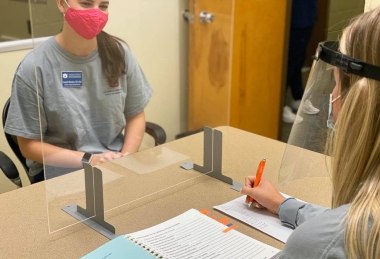 Student working with a client in the speech and hearing clinic