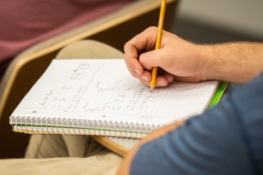 Person writing in notebook