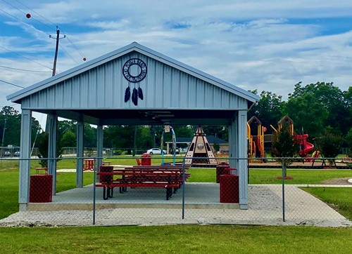 The picnic area and playground are enclosed with a chainlink fence