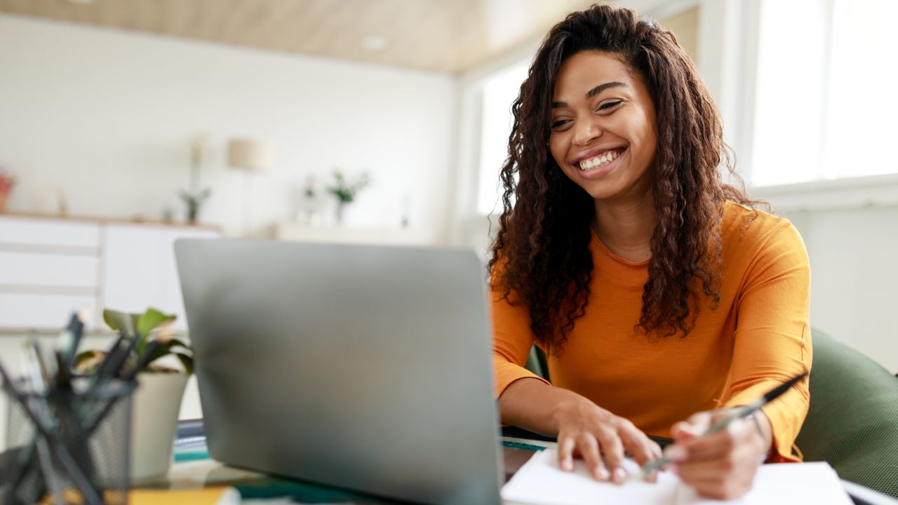 woman sitting in a chair looking at a computer screen