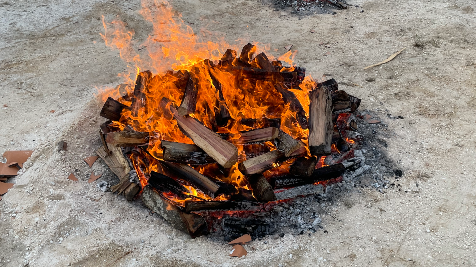 Image of a fire being built on top of the pots
