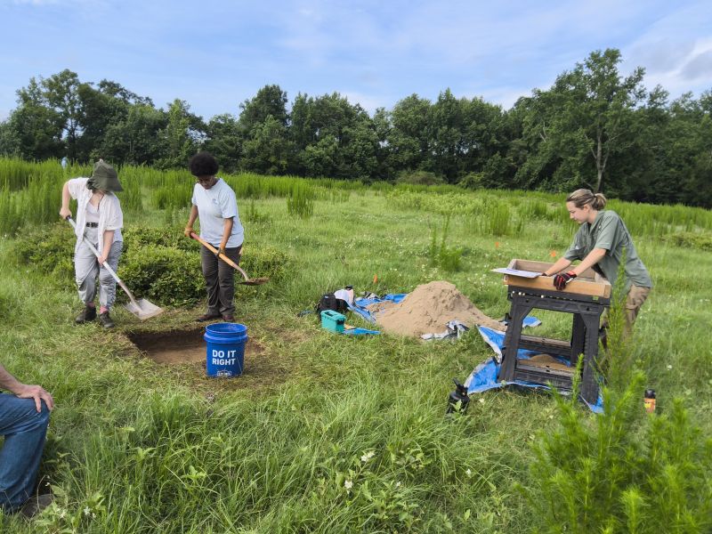 students excavating and screening