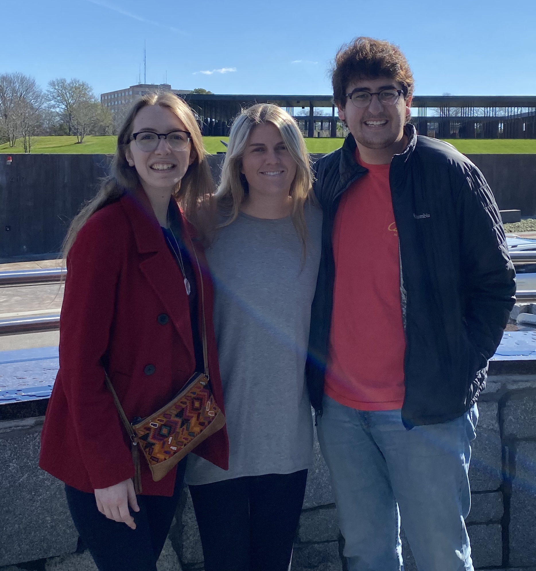 Two women and one man smiling