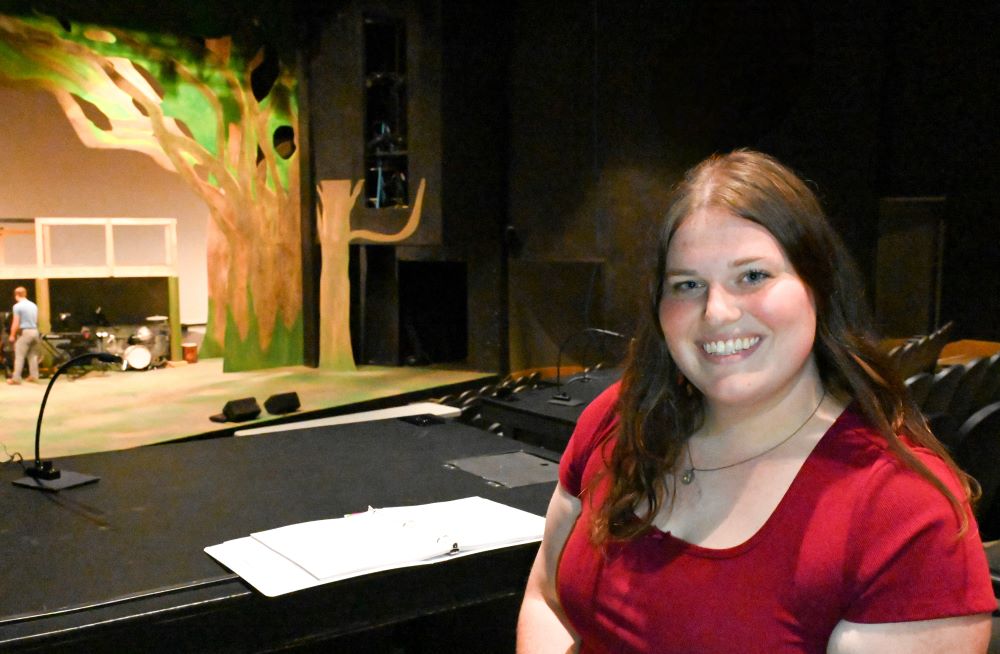 Amy Roberts sitting above the stage