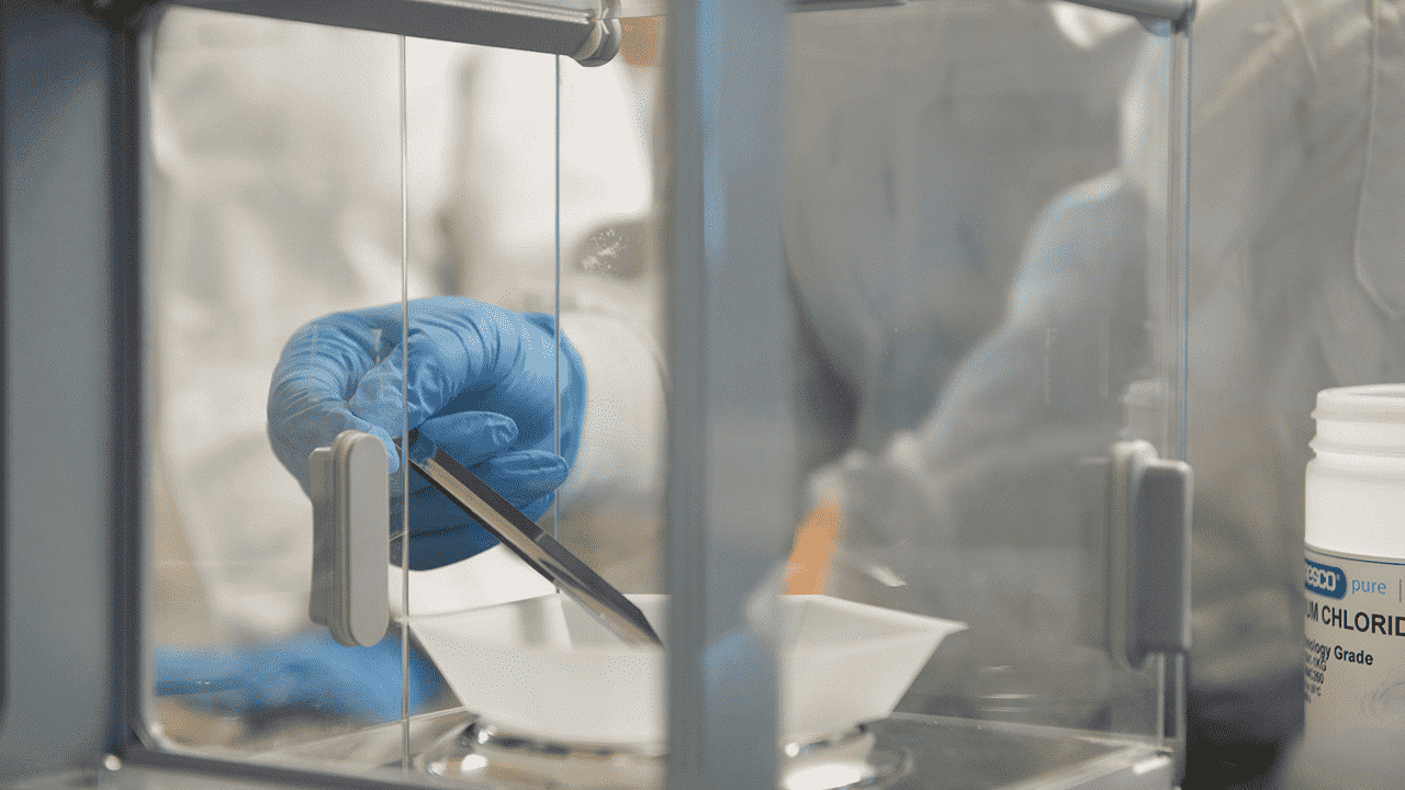 gloved hand shown in laboratory experiment setting