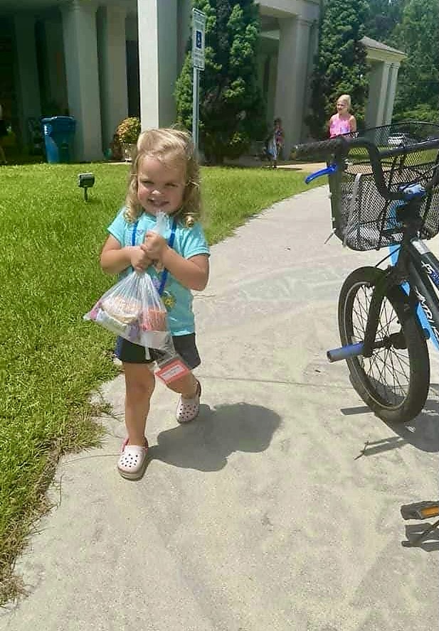 Caroline Williams carries her Feeding the Gulf Coast lunch provided during the summer. Contributed by Becky Williams.