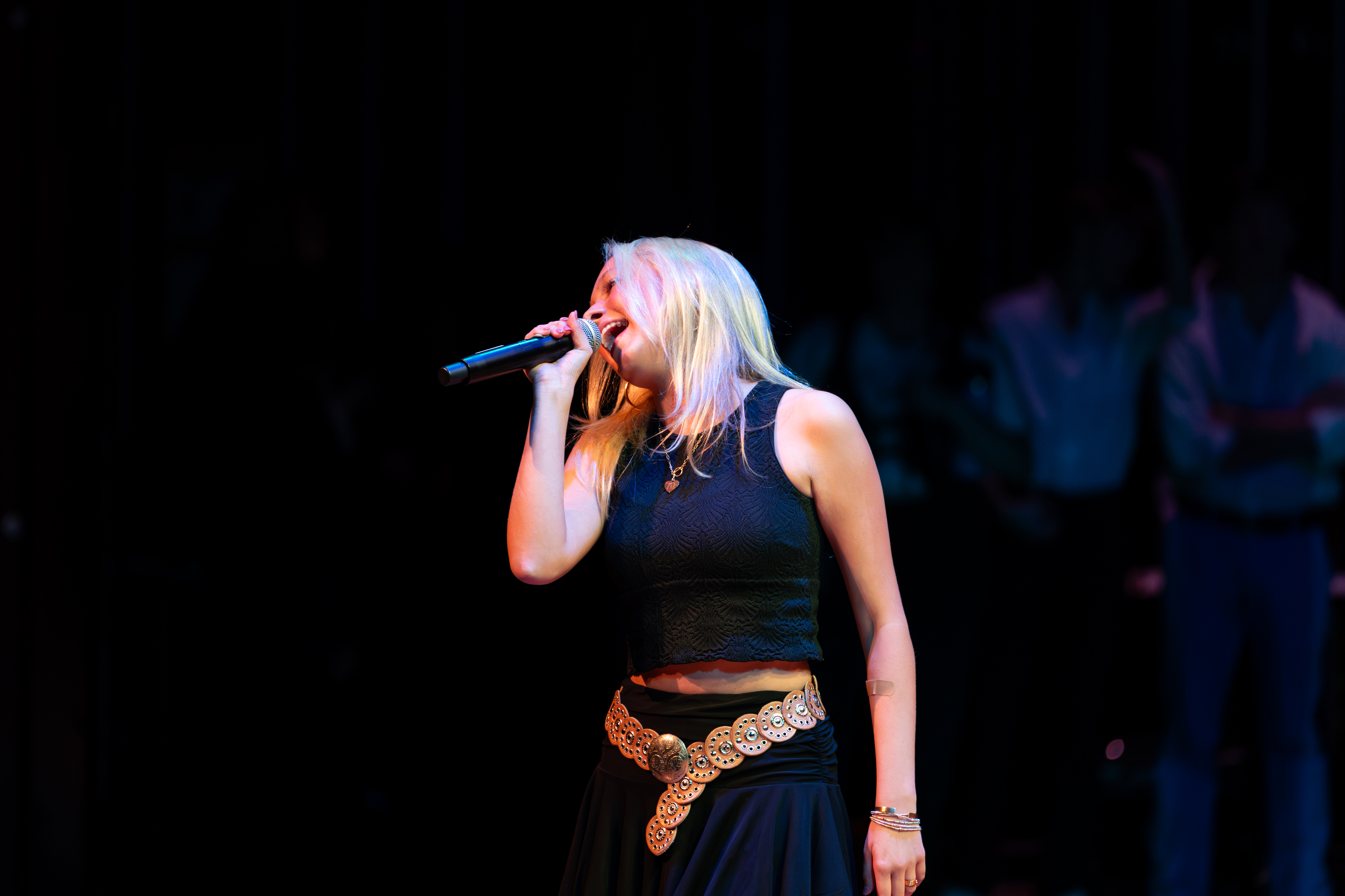 Student singing into a microphone