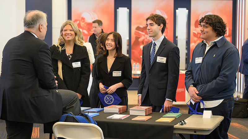 Students speaking with a law school representative at Auburn's Law School Fair