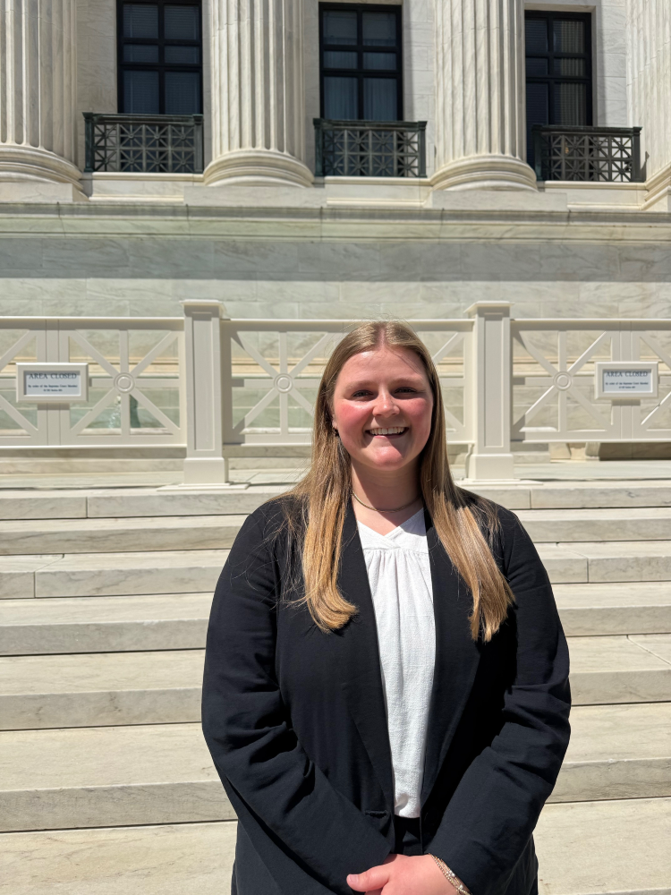 Lilli Wellbaum standing on the steps of the U.S. Supreme Court building