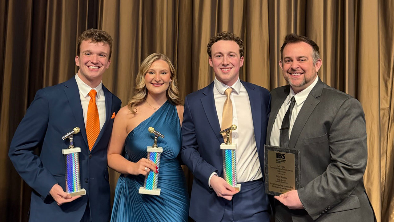 Students Vince Wolfram, Sydney Babb and Jack Corbett from Eagle Eye TV and advisor Billy Ferris holding Intercollegiate Broadcasting System Awards