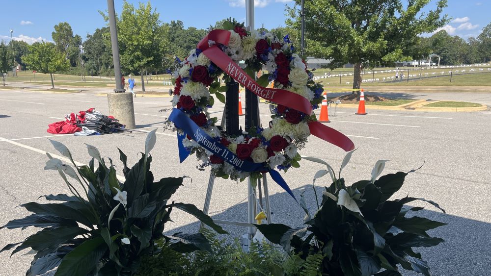 A red, white and blue wreath with ribbons reading &quot;Never forget September 11, 2001&quot;