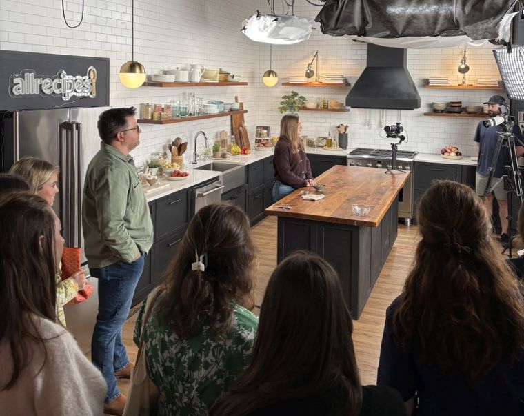 Students standing in a kitchen studio