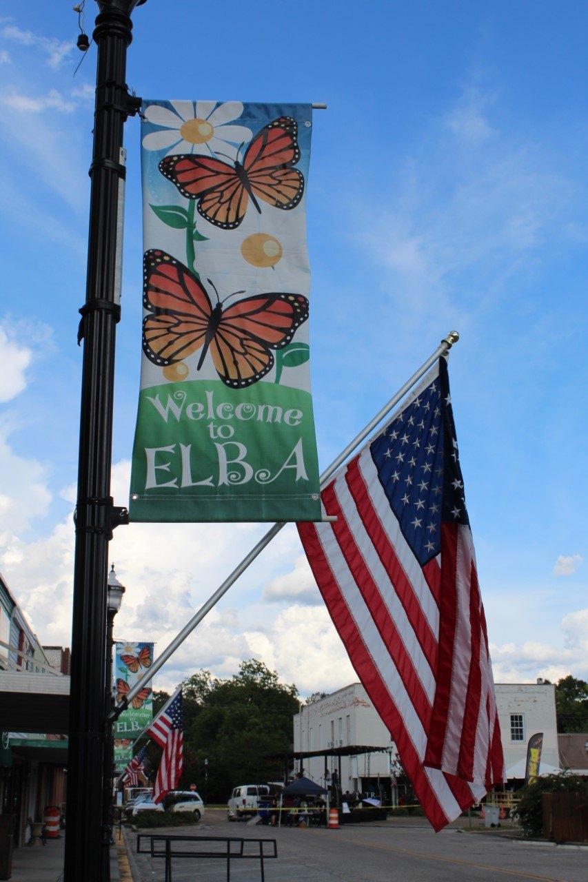 Elba banner hanging next to American flag