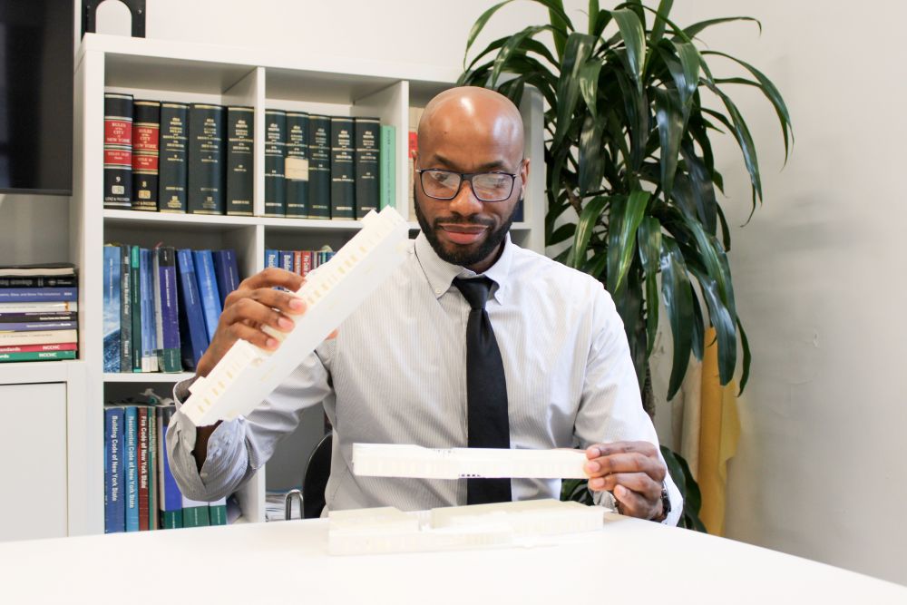 Bradley DeBose holding an architectural model