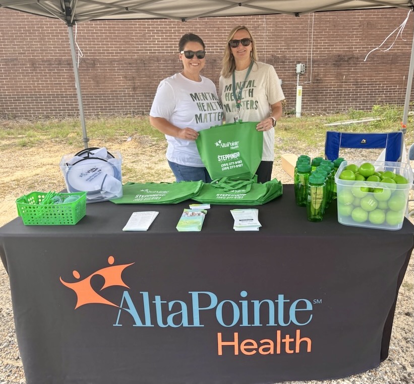 Ashley Blount and Janice Long set up a table outside the Chatom Post Office for “Go Green” month.