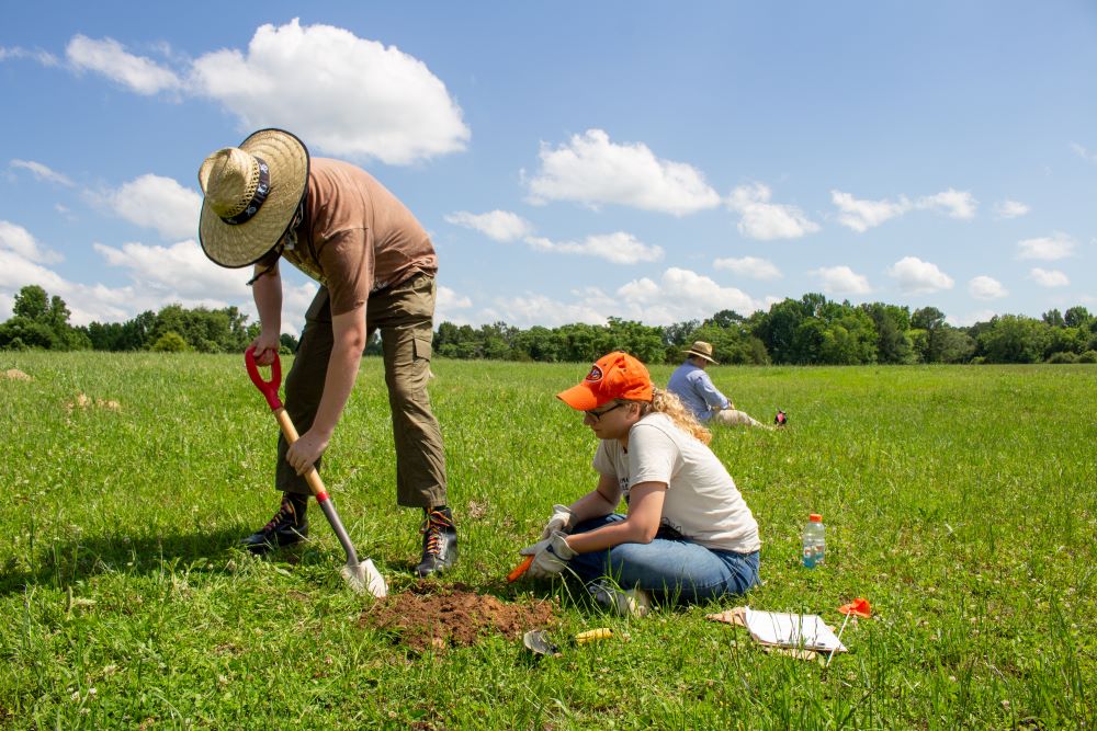 Students shovel testing land at Camp Watts