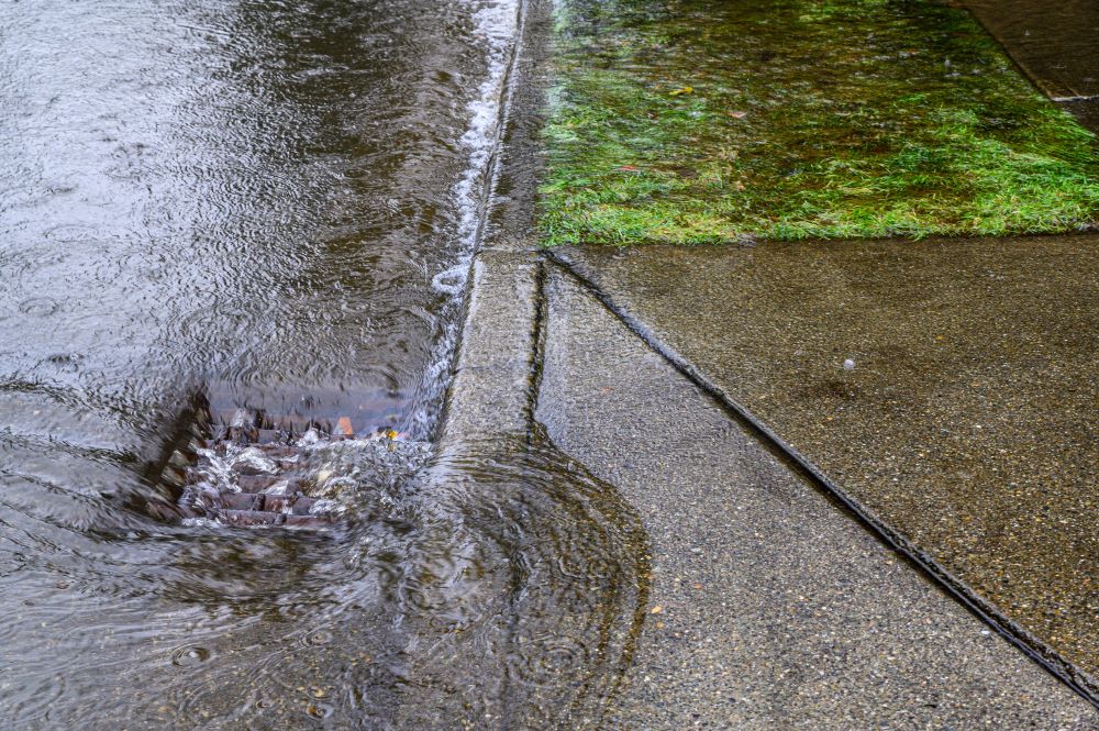 Water pouring down a storm drain during flood