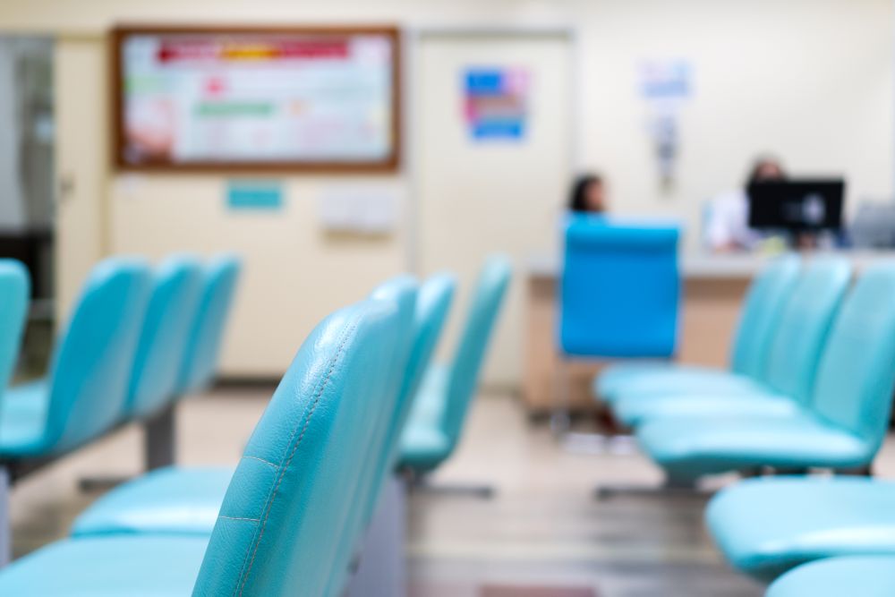 Rows of empty chairs sitting in a hospital waiting room