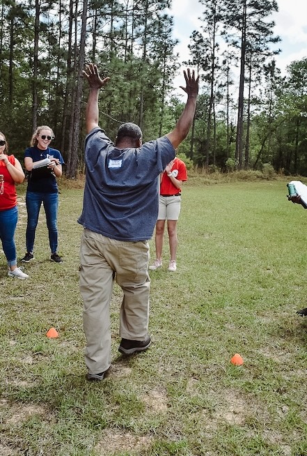 a man prepares to do a cartwheel while friends cheer him on