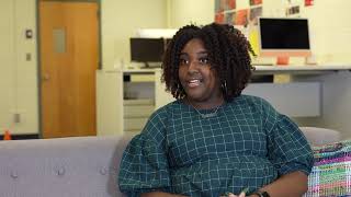 Woman pulling a legal volume from a bookshelf in a library