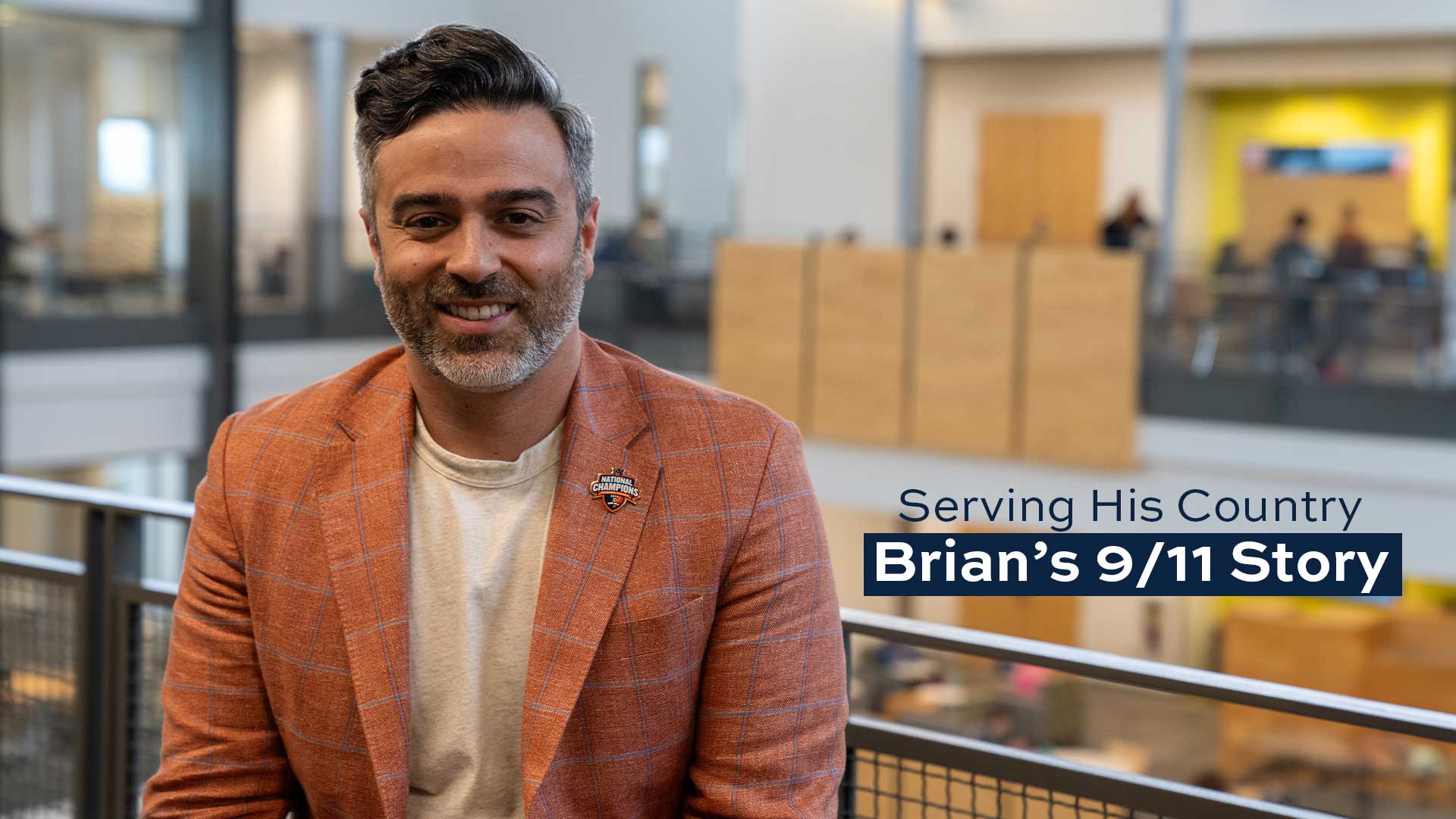 Brian Pultro poses for a picture with an atrium behind him.