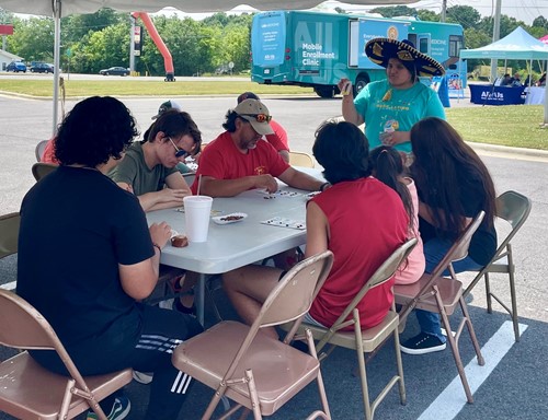 Festival goers play games at tables