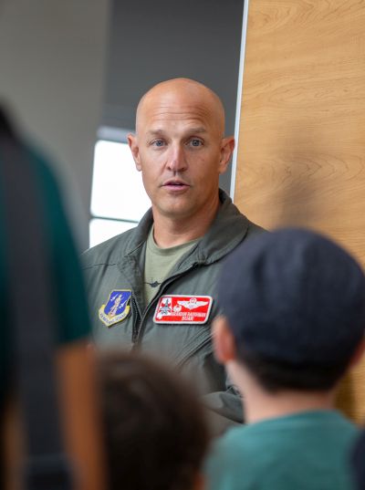 Flight instructor speaking to a group of kids